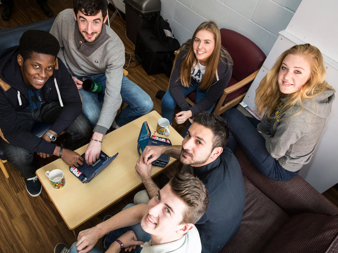 students sitting at a table smiling