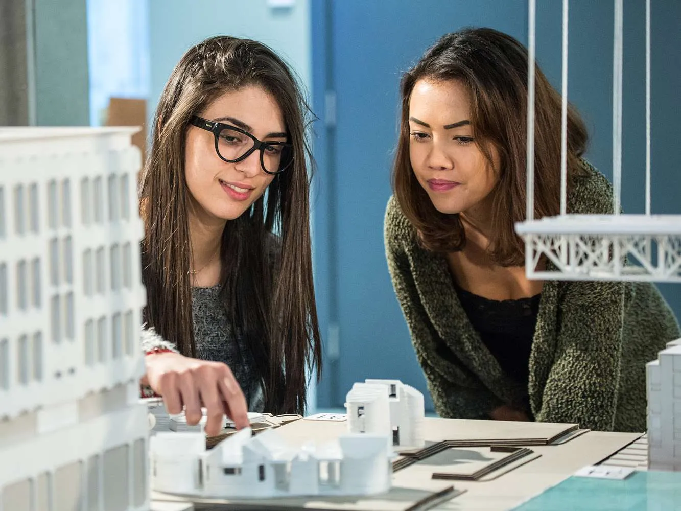 two students looking at an architectural model