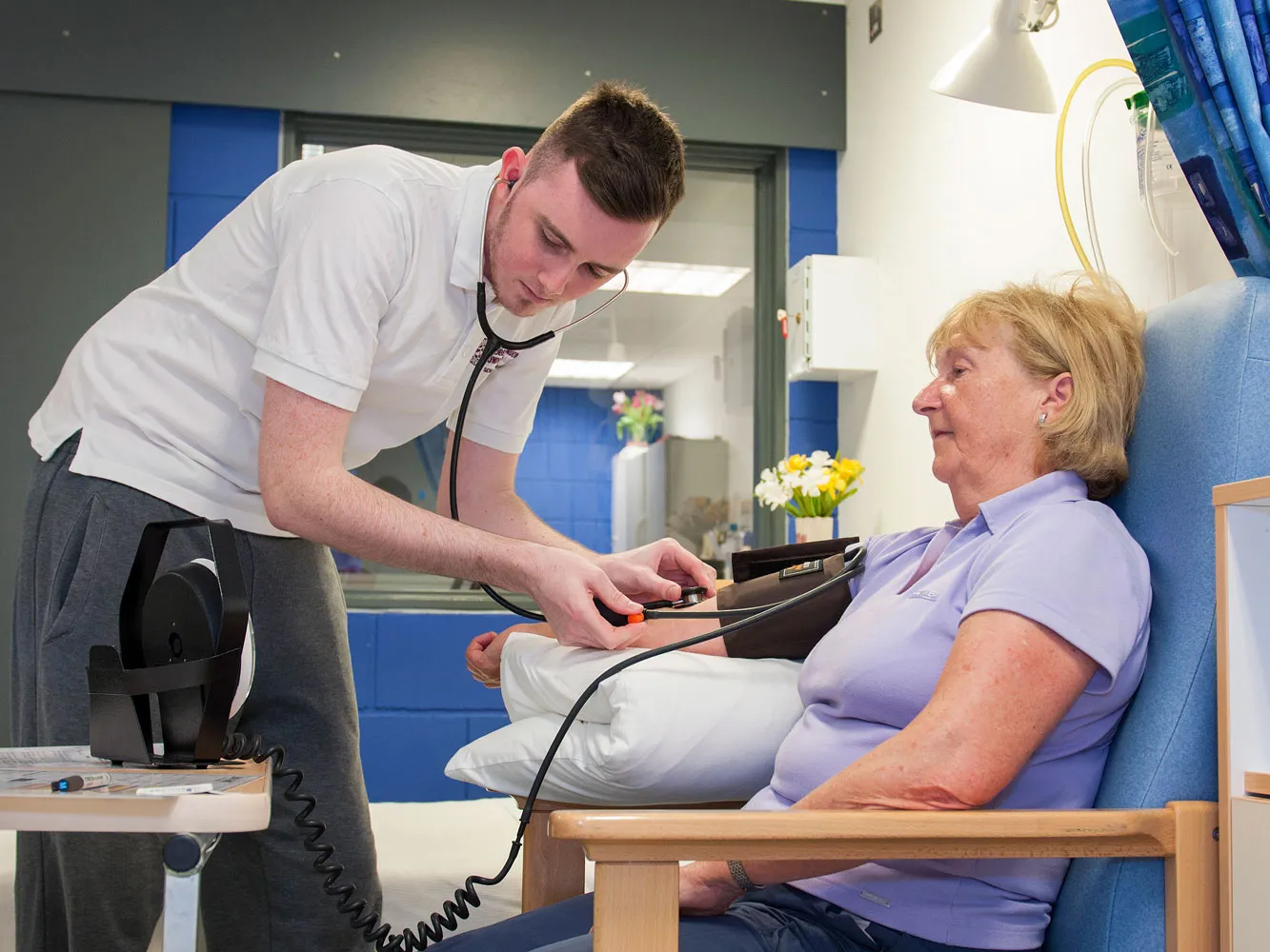 nurse taking patient's blood pressure