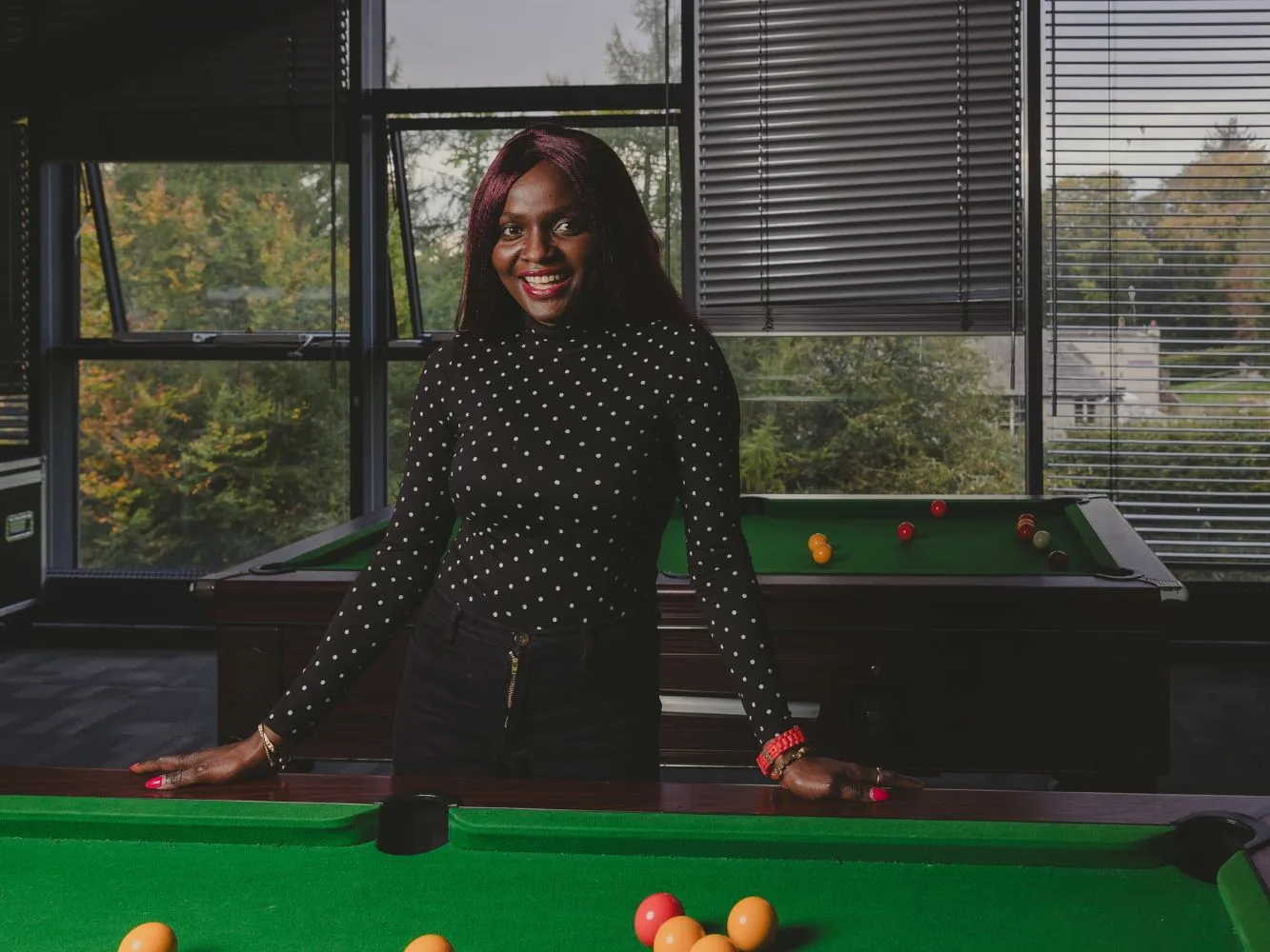 RGU student Blessing Buluan standing at a pool table