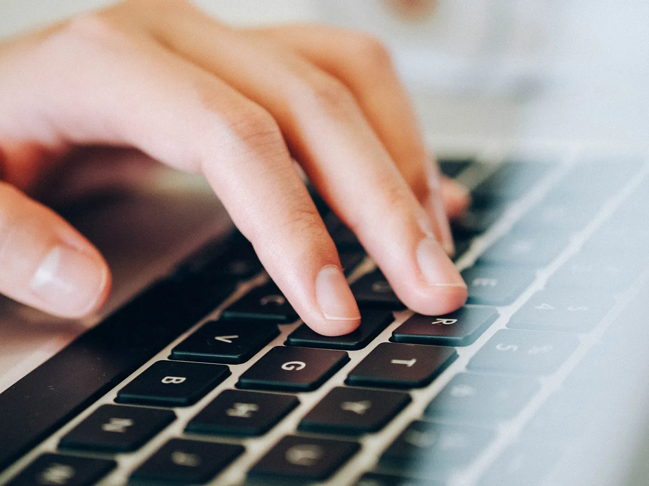 fingers typing on a keyboard