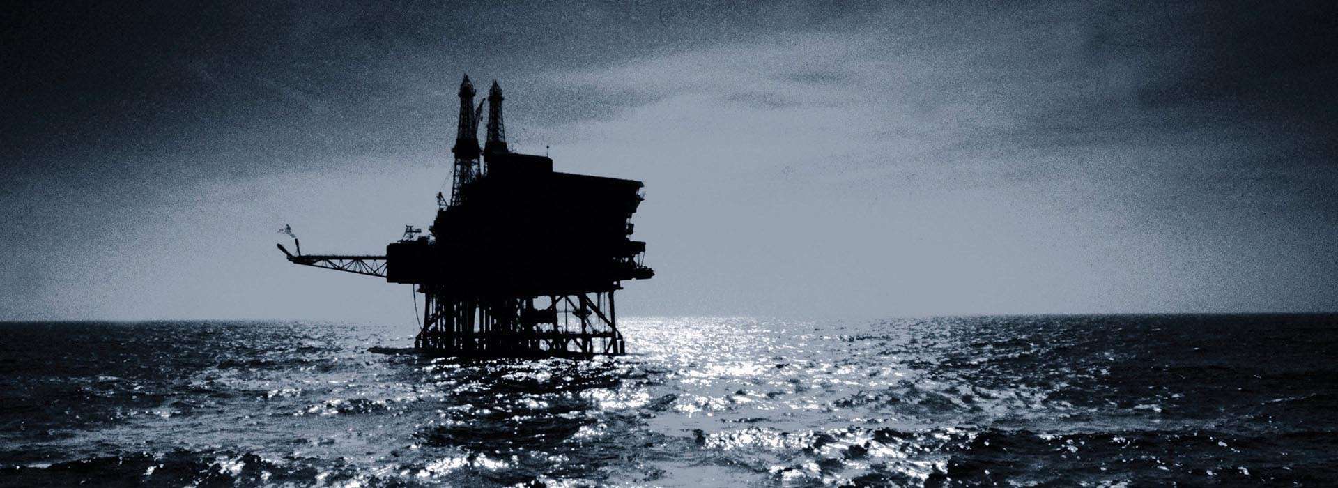 dramatic photo of an oil rig at sea