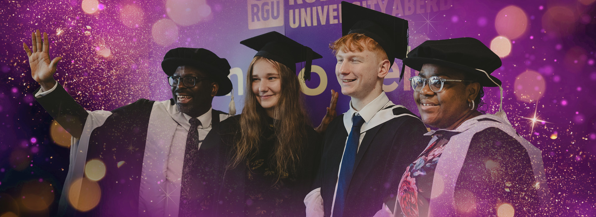 Graduates celebrate in their gowns