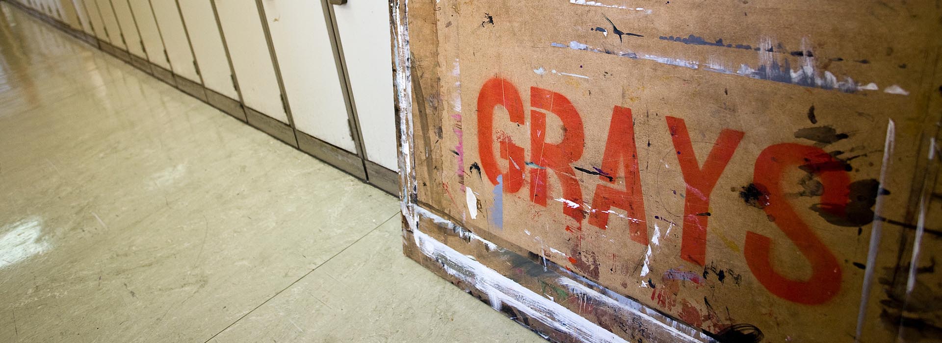 An art board with the word Grays sprayed on to it in red paint