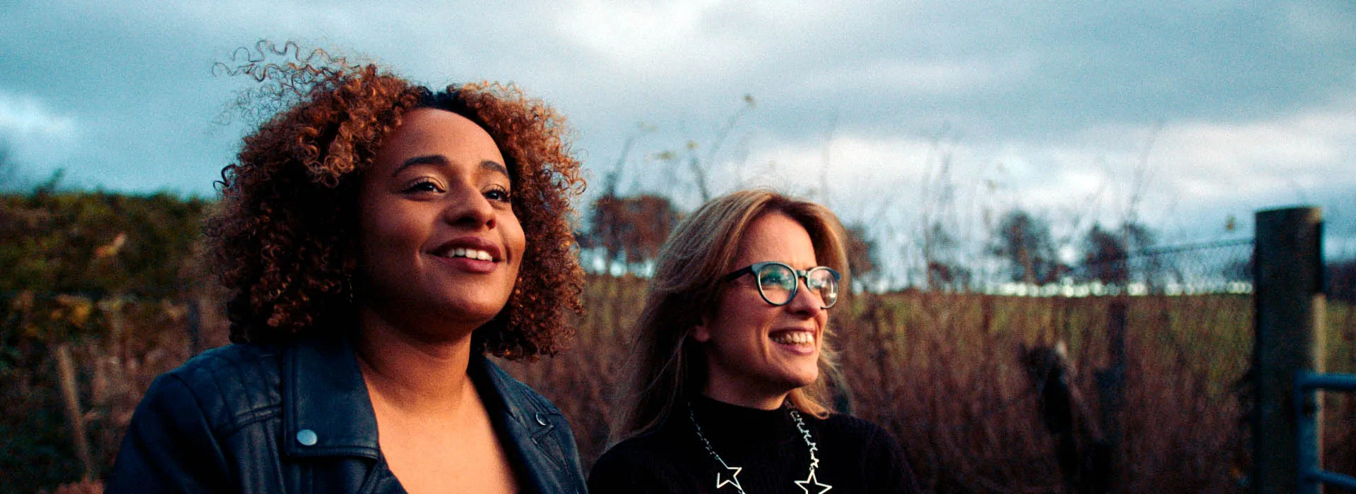 Two people standing in a field