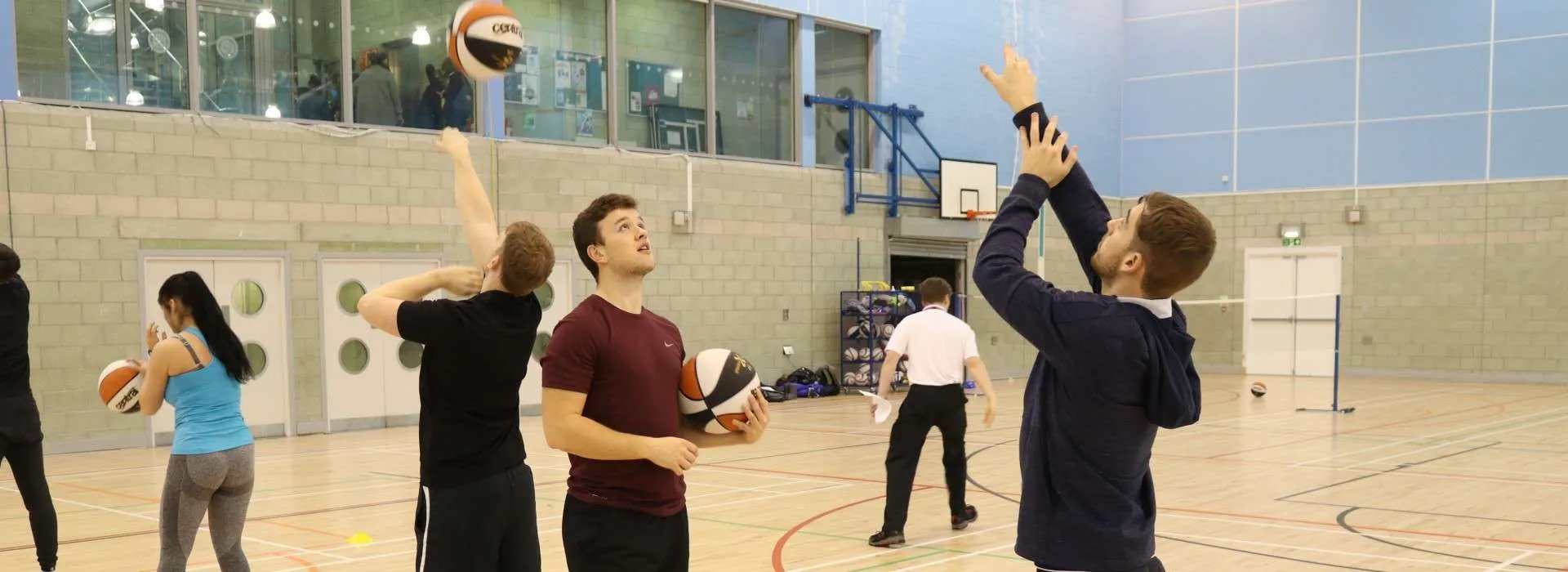 students practicing basketball together