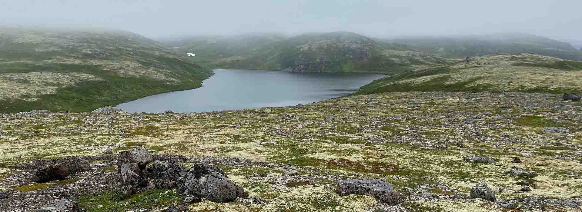Lake in midst of green hills