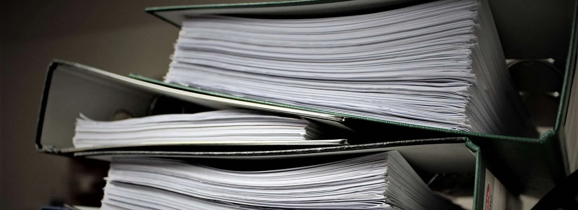 stack of binders full of paper