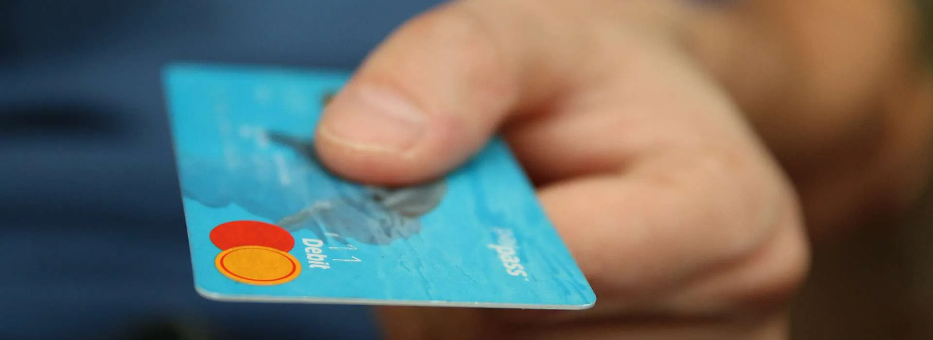 hand holding a debit card