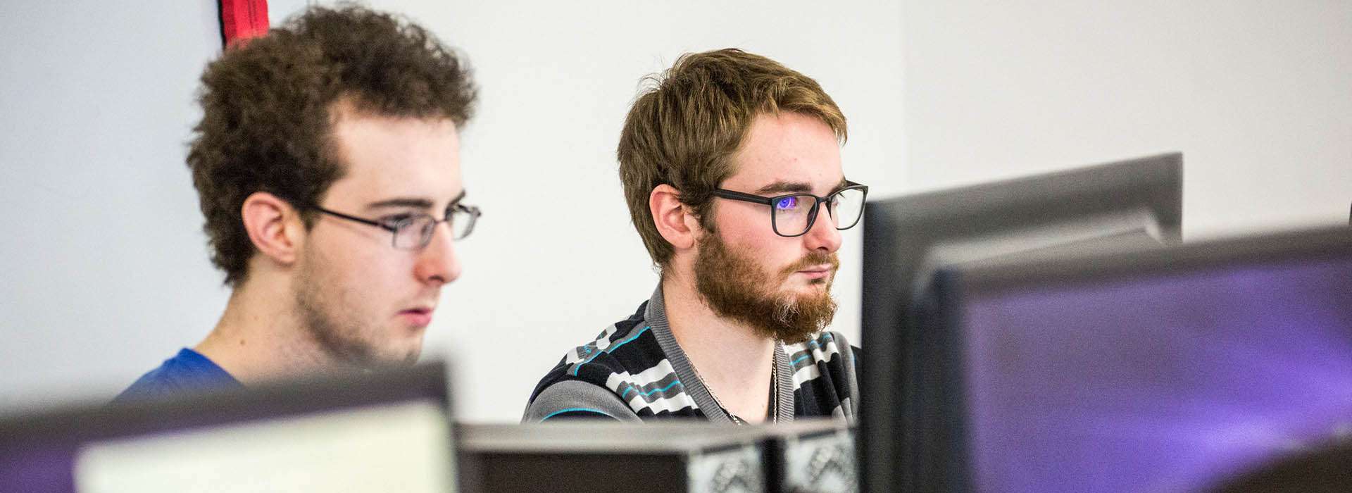 students looking at computers in lab