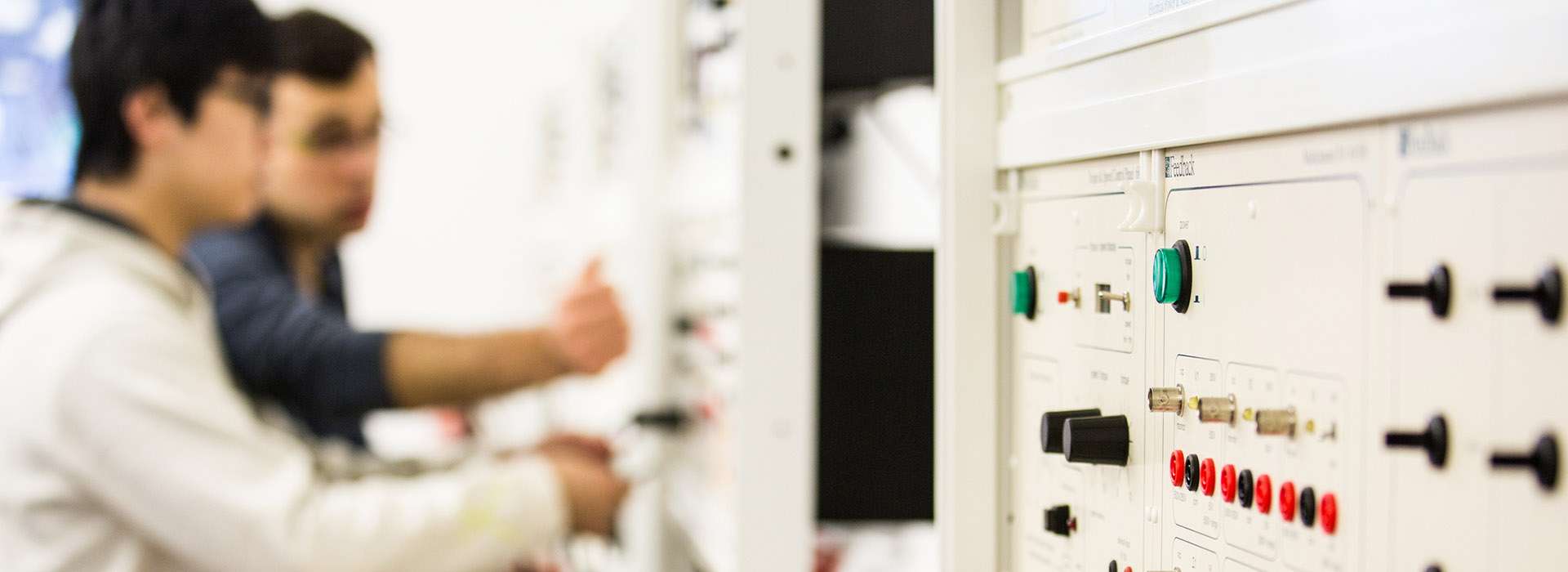 two people using electrical control panel