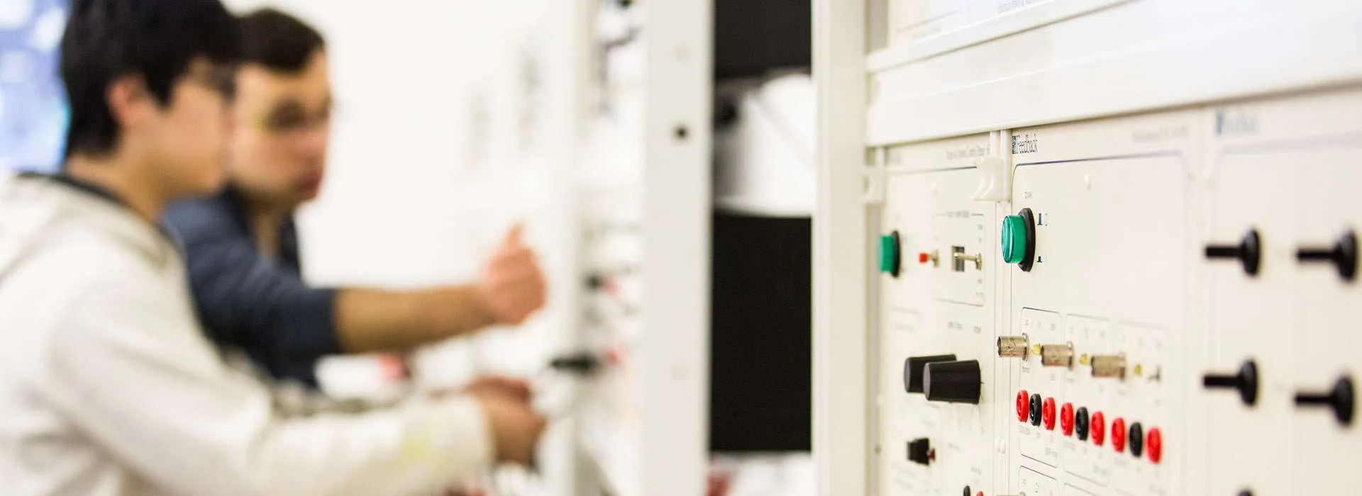 two people using electrical control panel