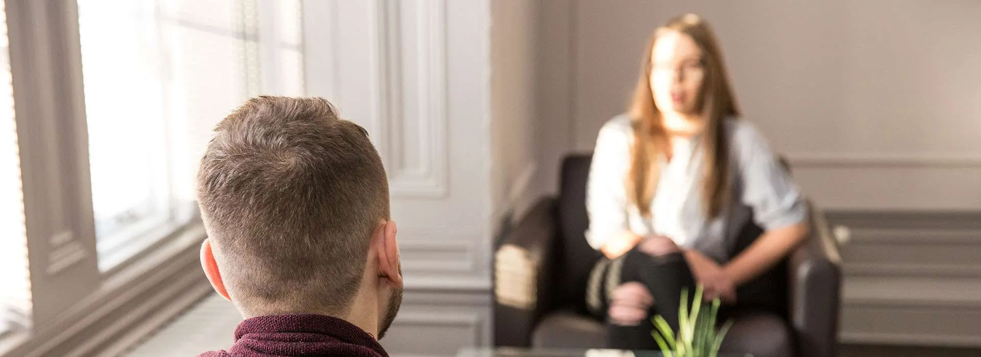 two people in a room having a serious conversation