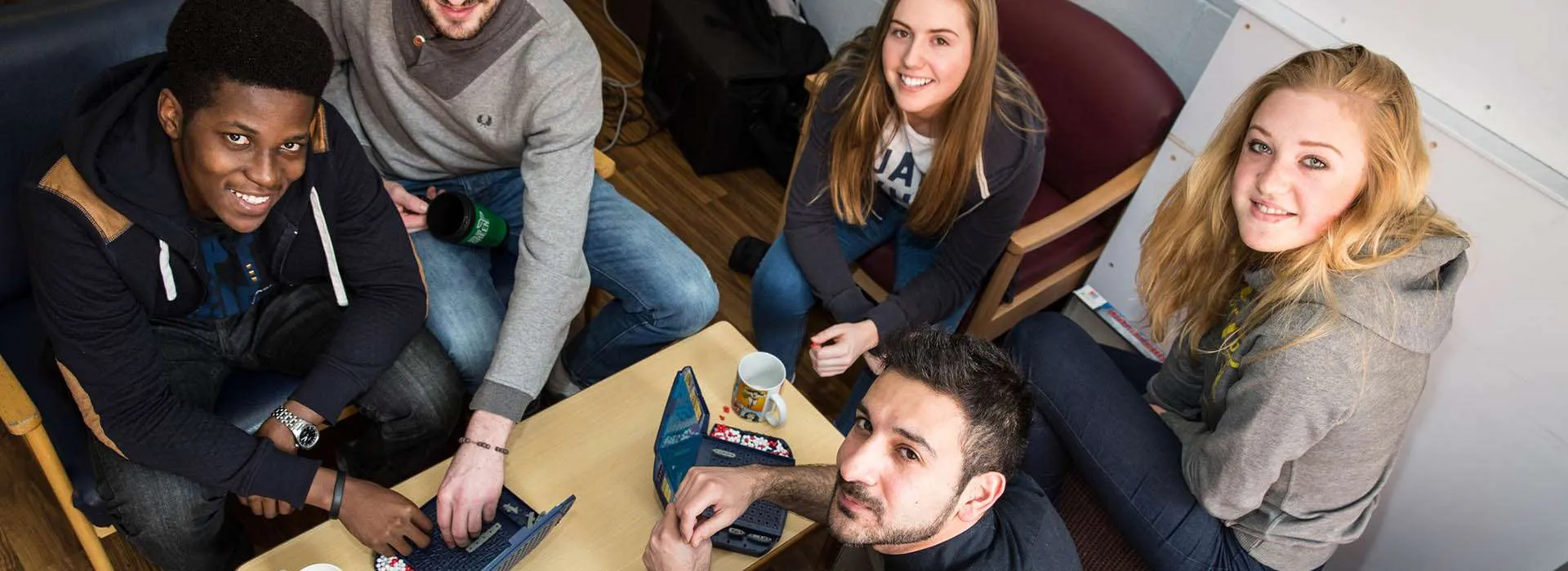 students looking up from table smiling