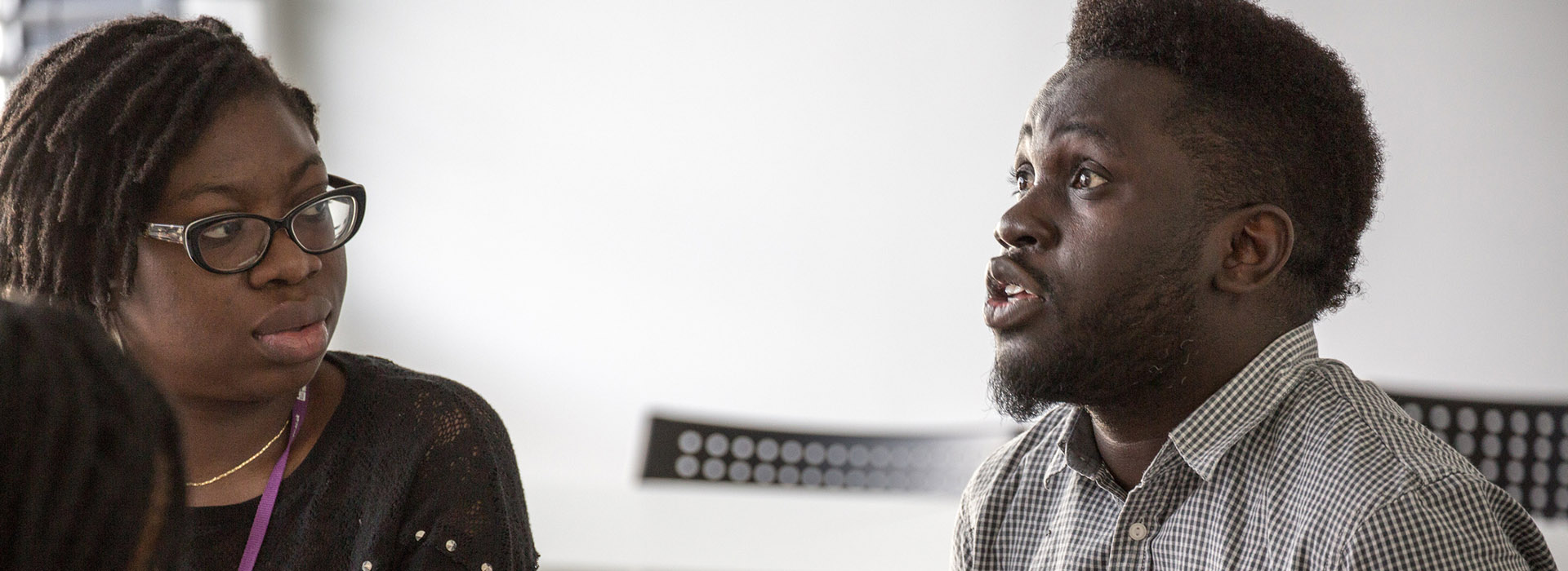 two people speaking in a classroom