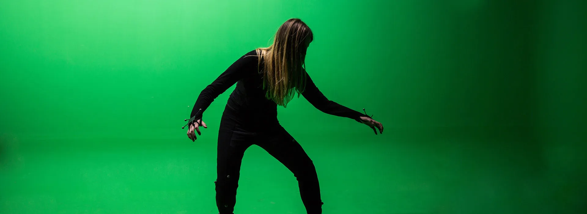 woman posing in front of green screen