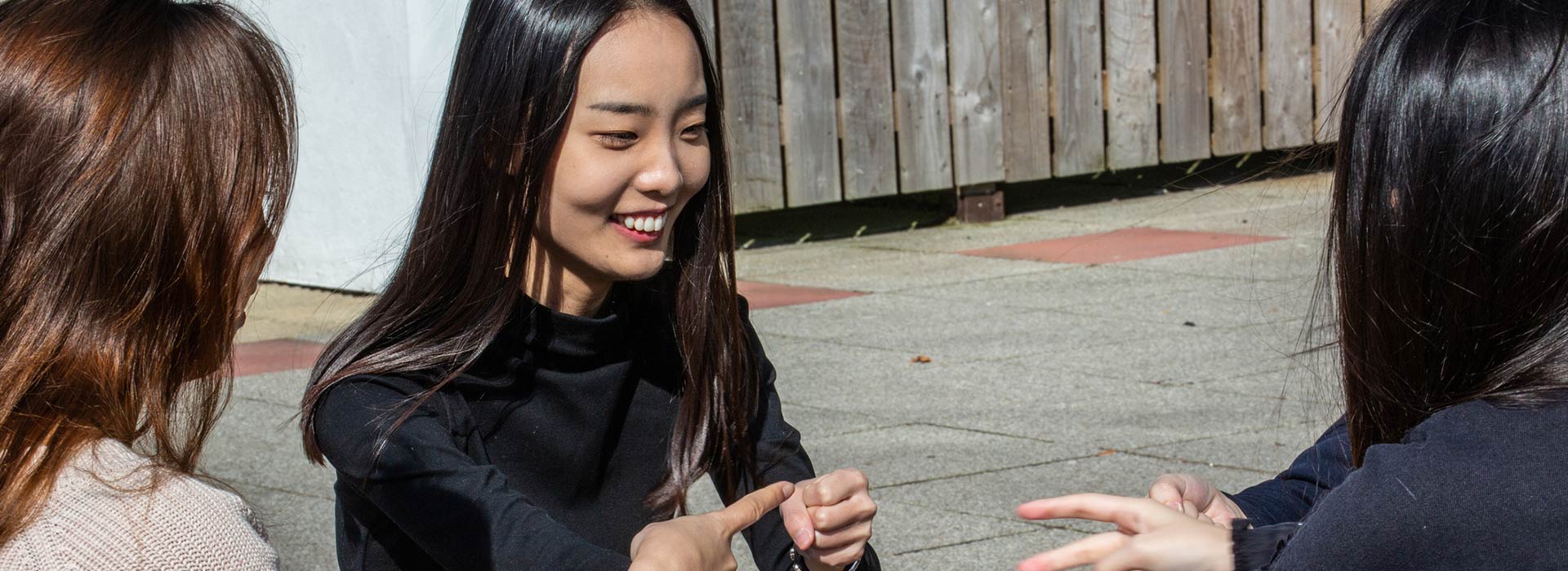 students laughing on a picnic bench