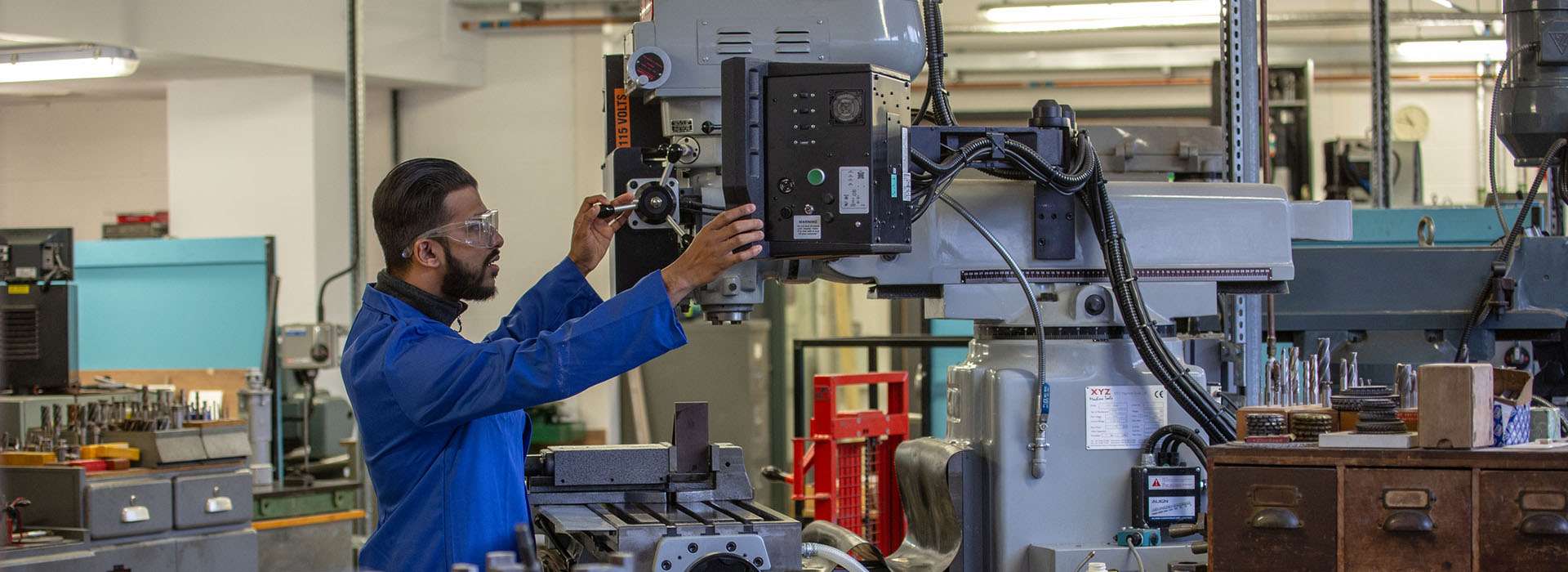 man working on device in engineering workshop