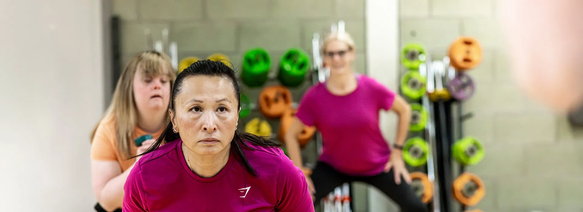 group of people exercising usign kettlebells