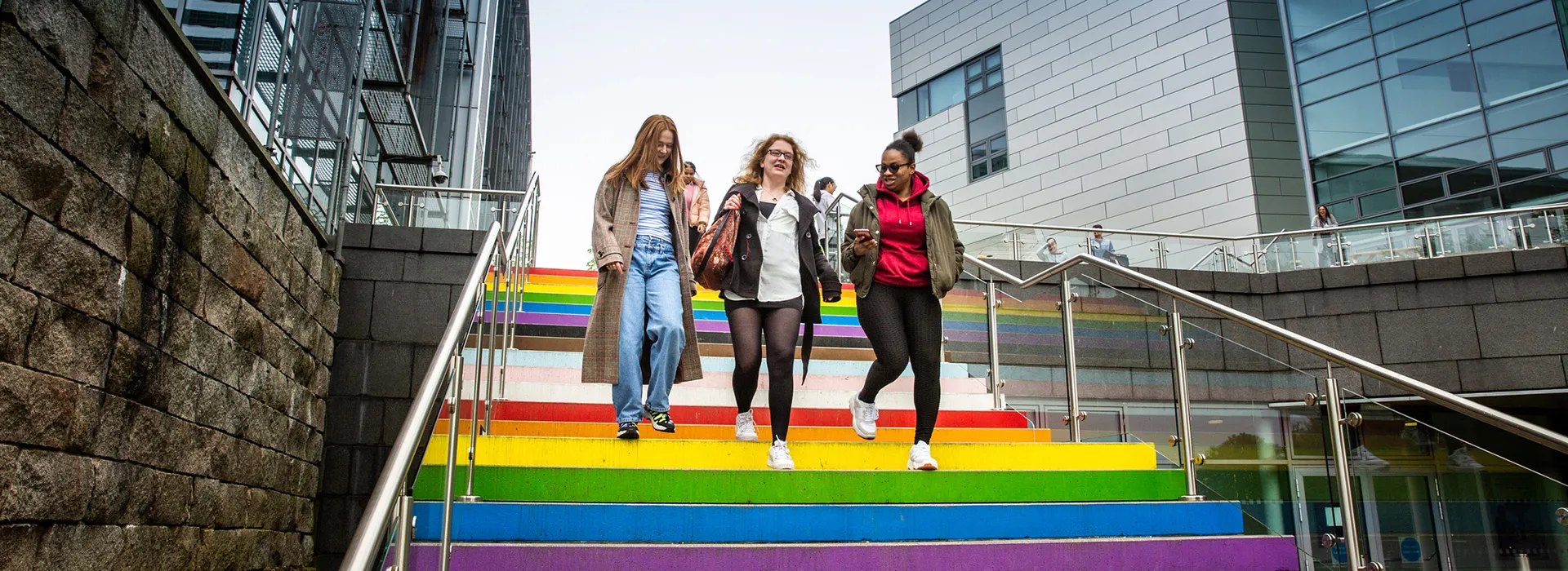 students walk down rainbow stairs at RGU campus