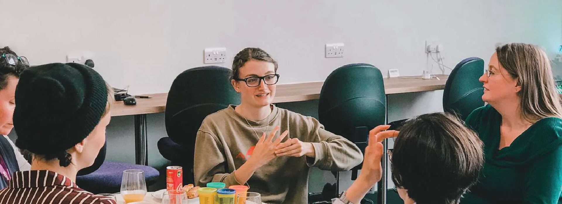 group of people chatting around a table