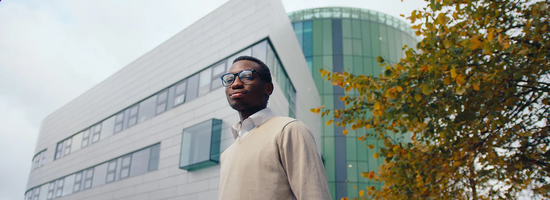 Student stands outside the Sir Ian Wood Building