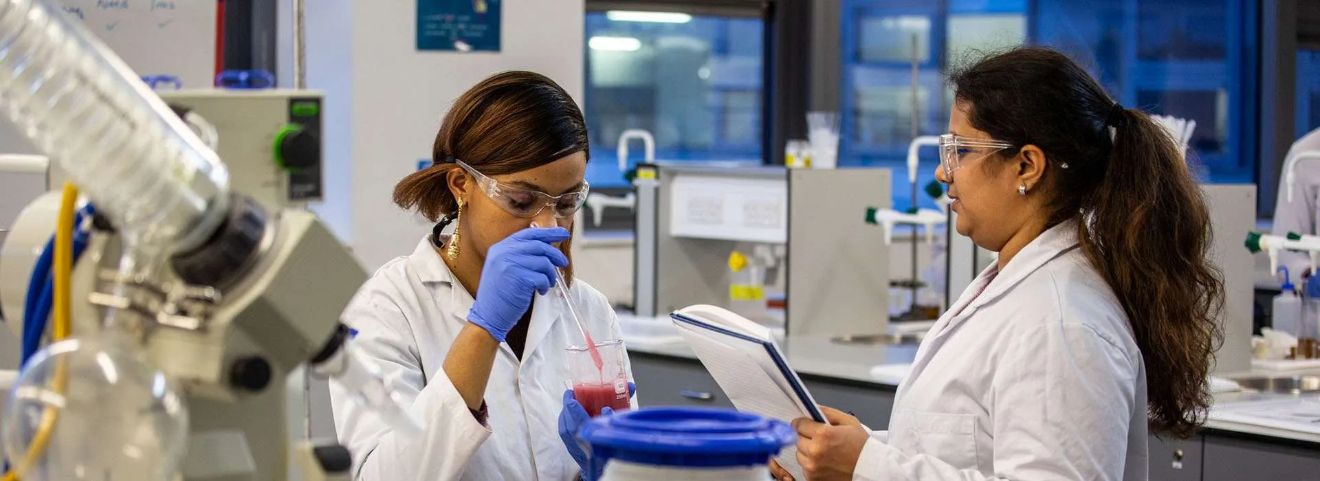students using dropper and beaker in a lab