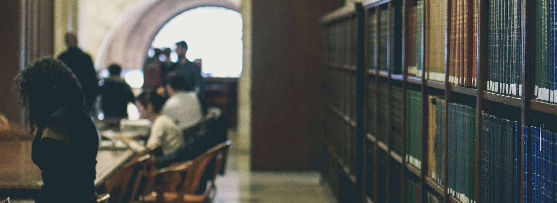 people working in an old fashioned library