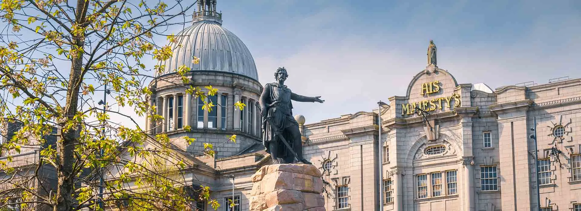 Statue at Aberdeen's Union Terrace Gardens with His Majesty's Theatre in the background