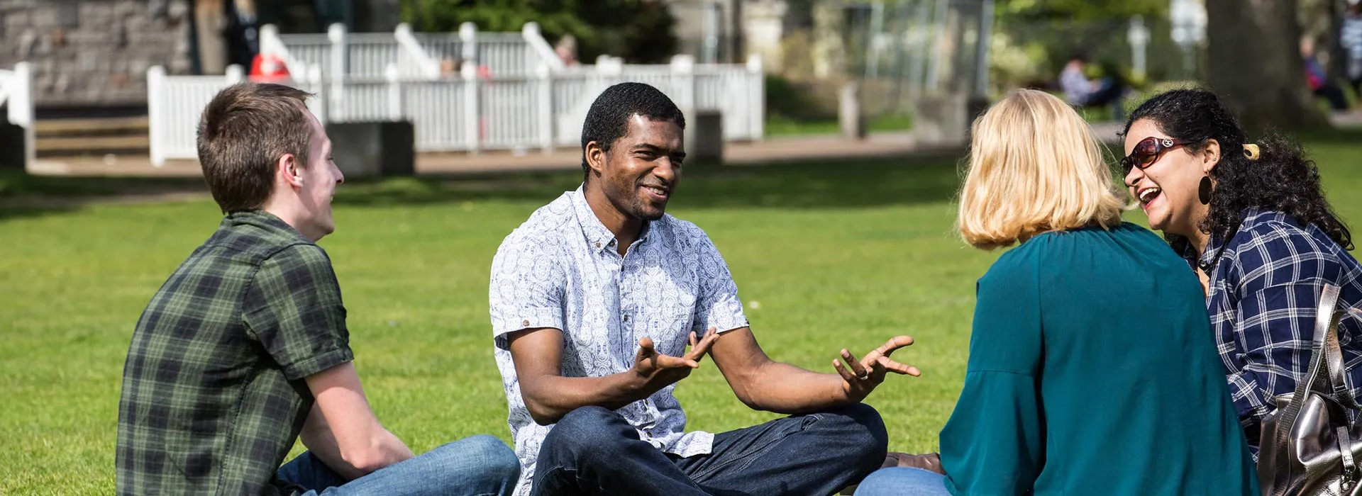 students chatting sat on the grass