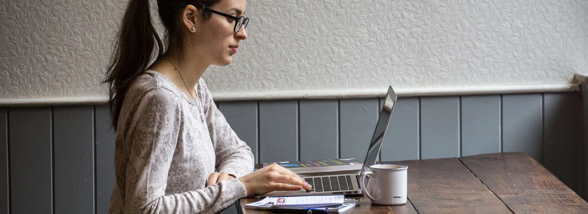 woman working on laptop in cafe