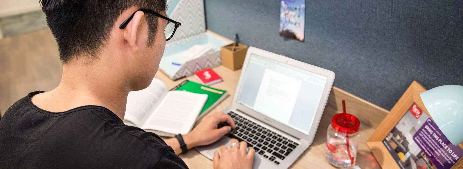 student working on laptop at their desk