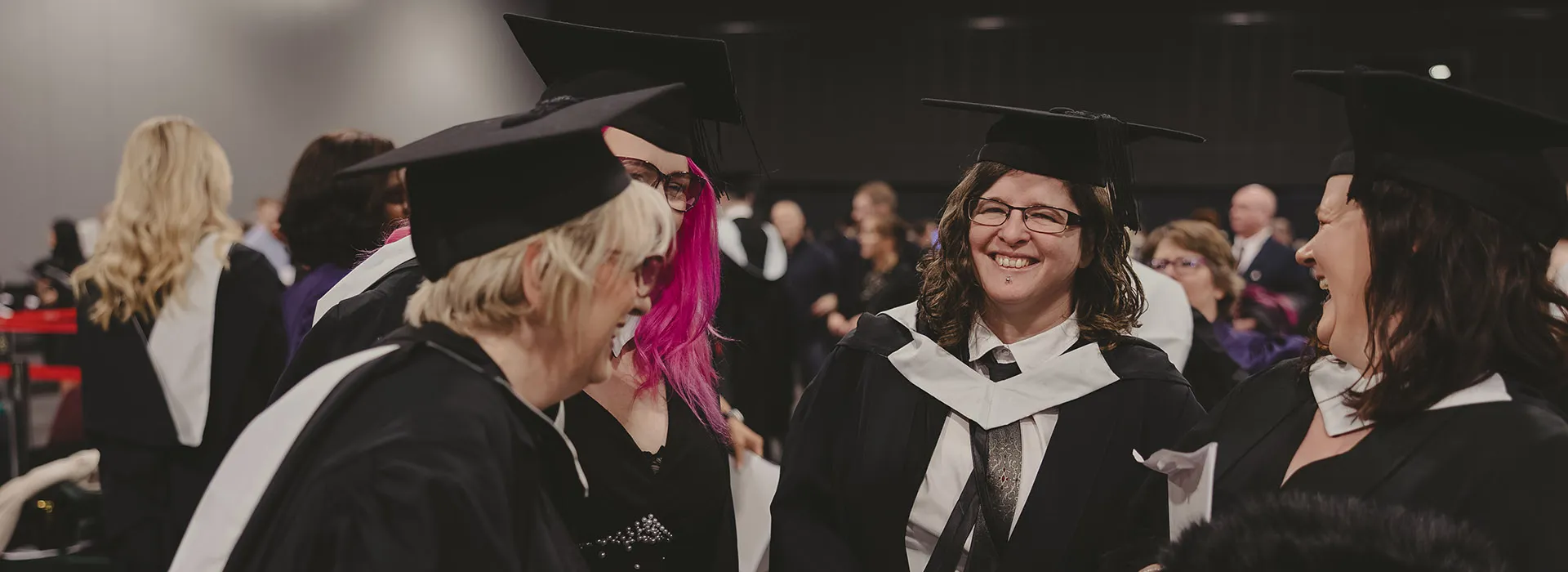 Four RGU graduates laugh together at P&J Live