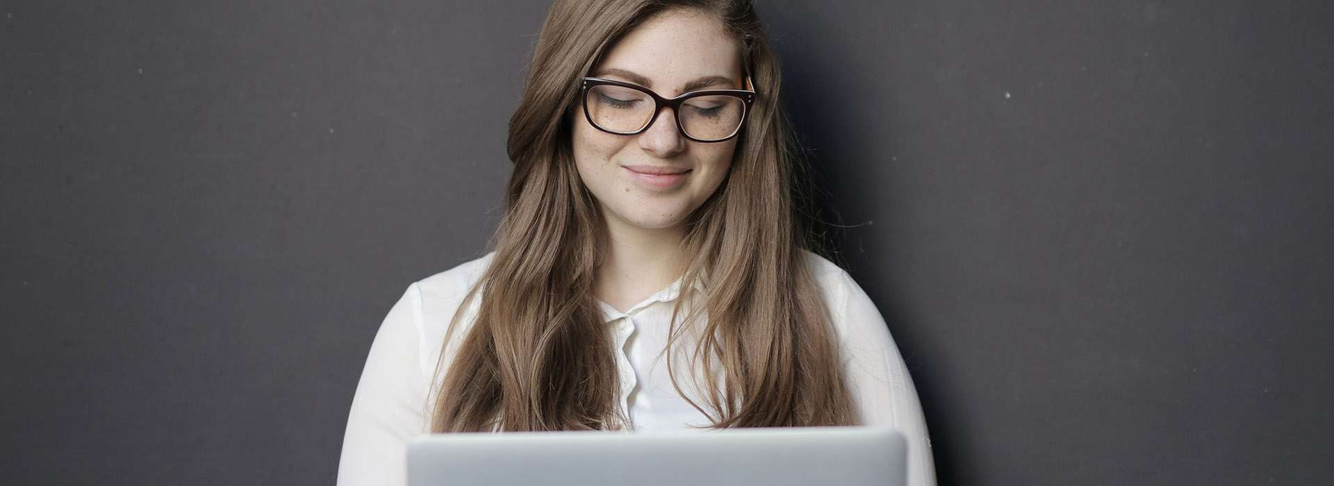 woman sitting cross legged with her laptop