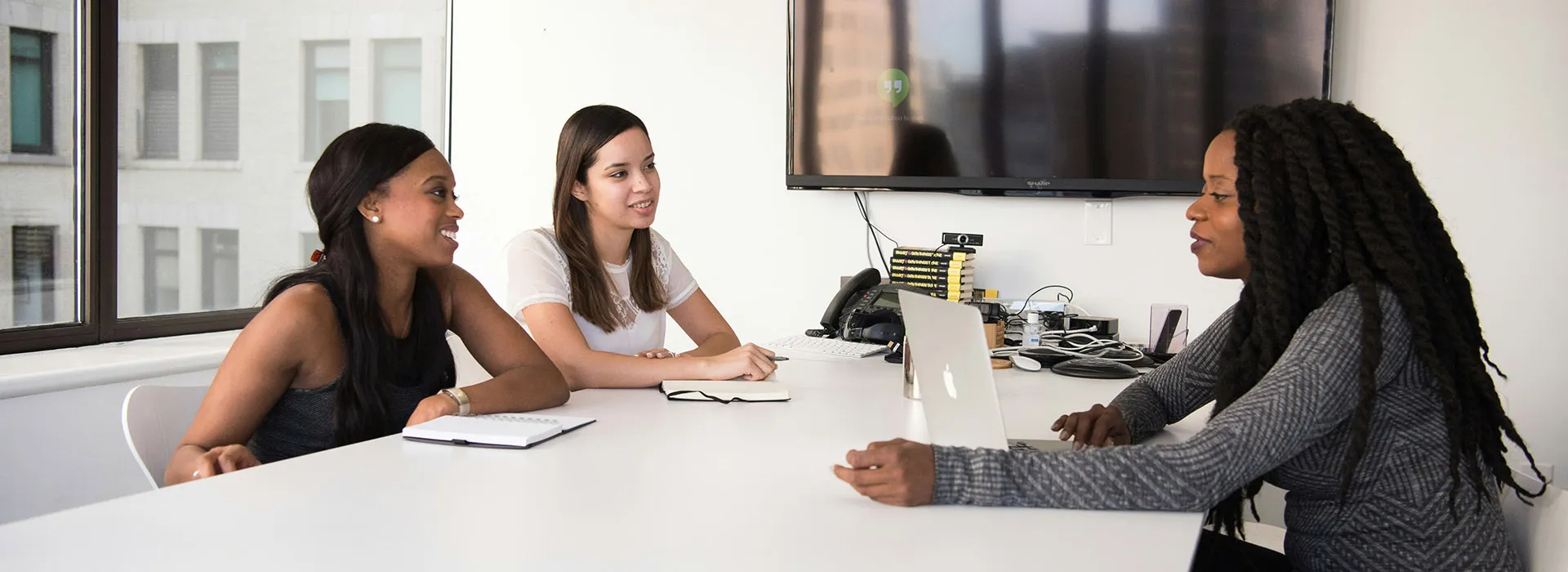 Three women meeting around a table