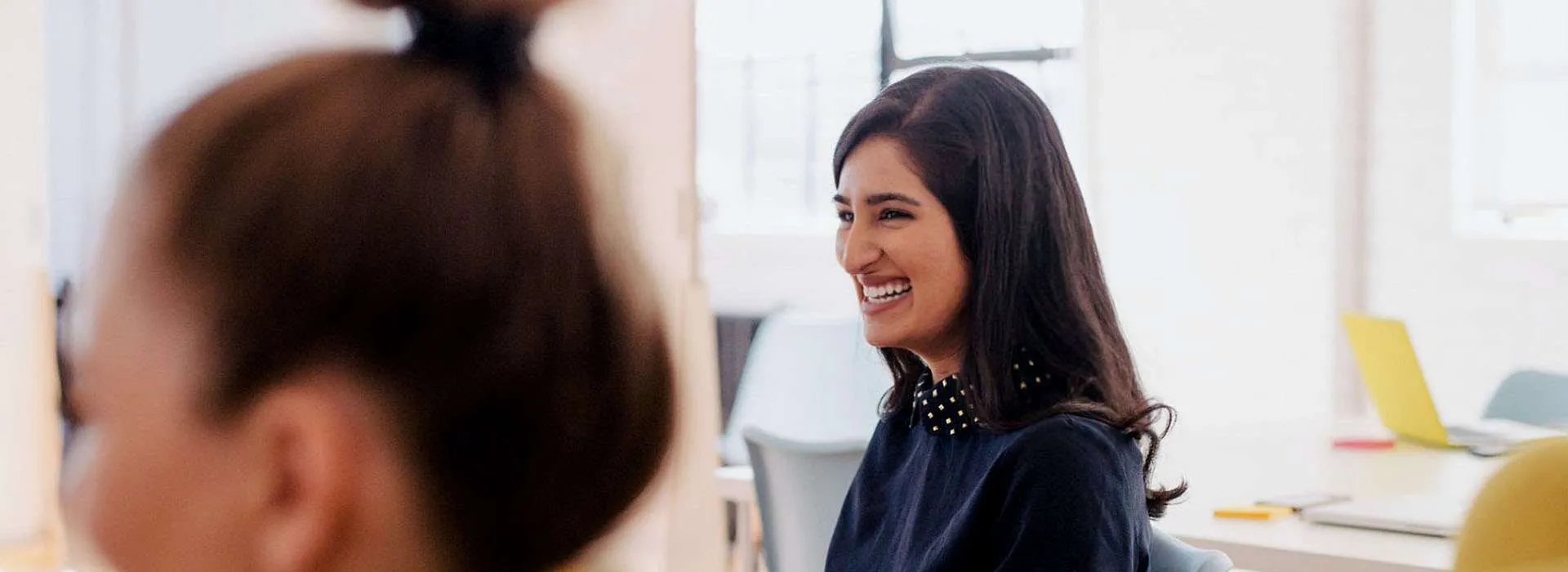 two women smiling together