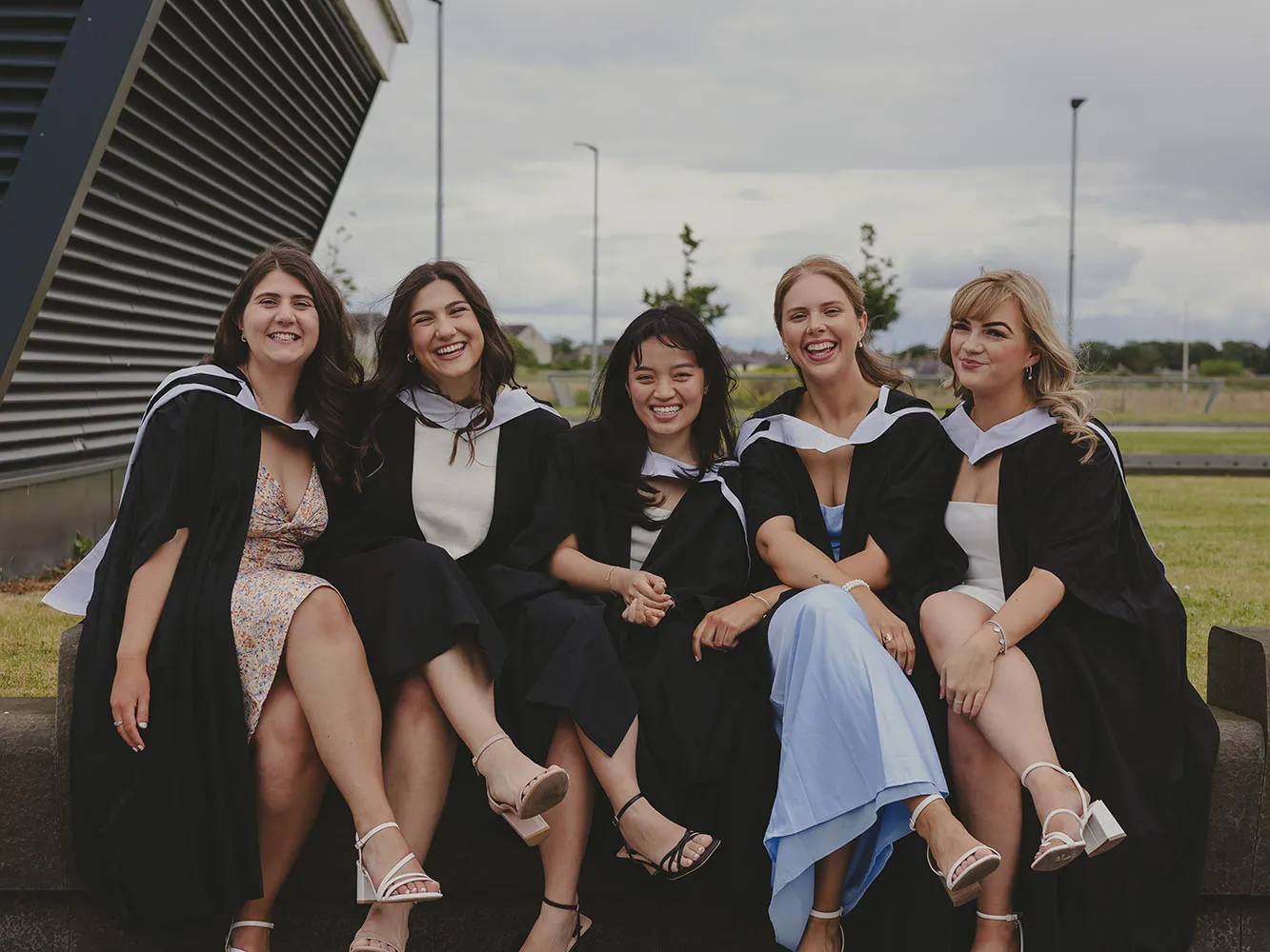 5 graduates pose for photo outside P&J Live