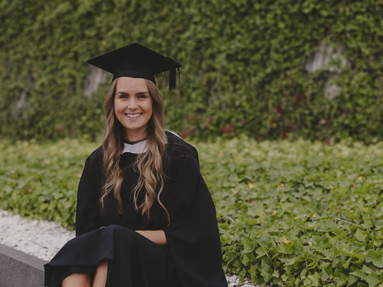 Aimee Work posing at graduation