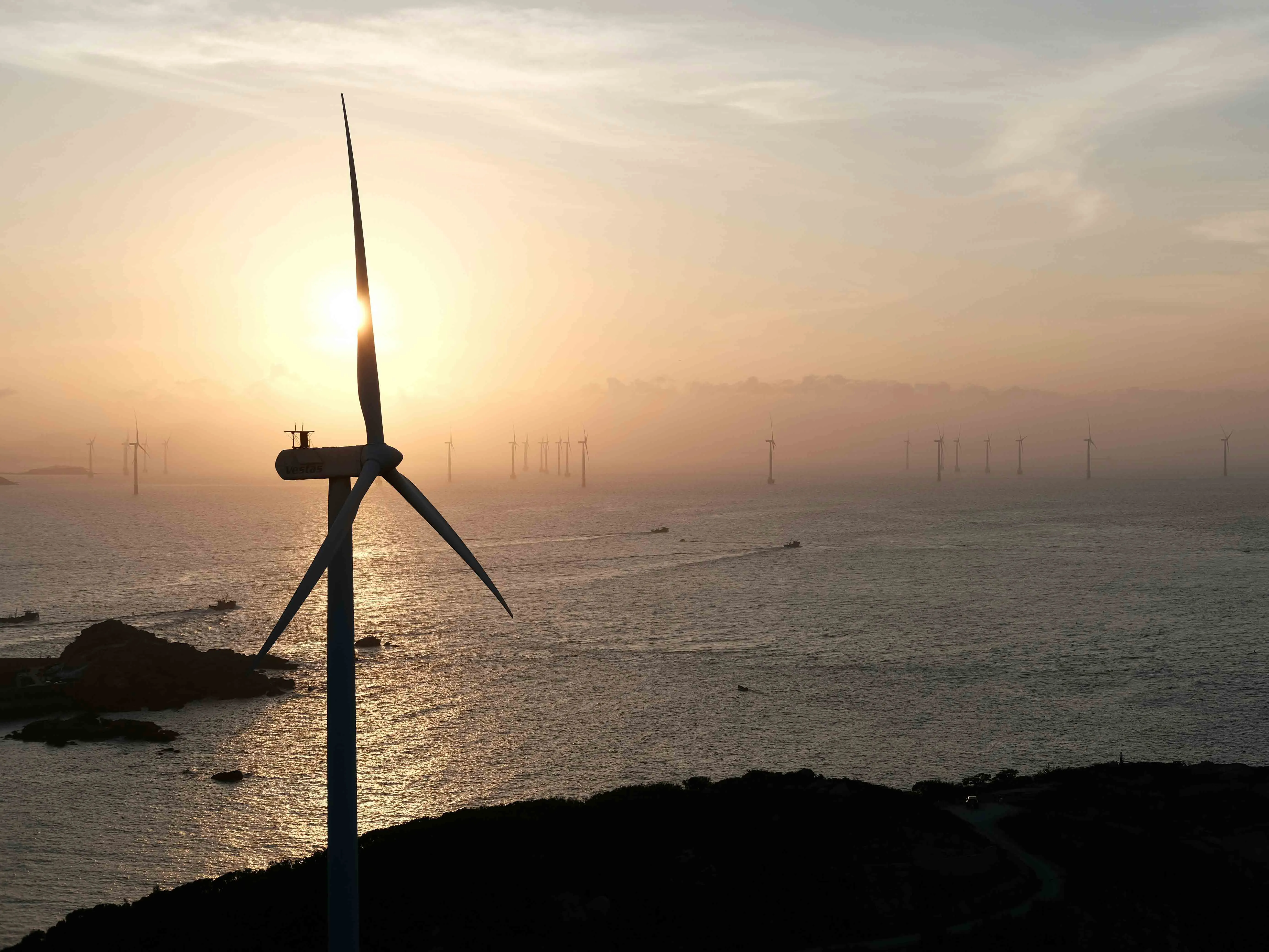 wind turbines by the ocean