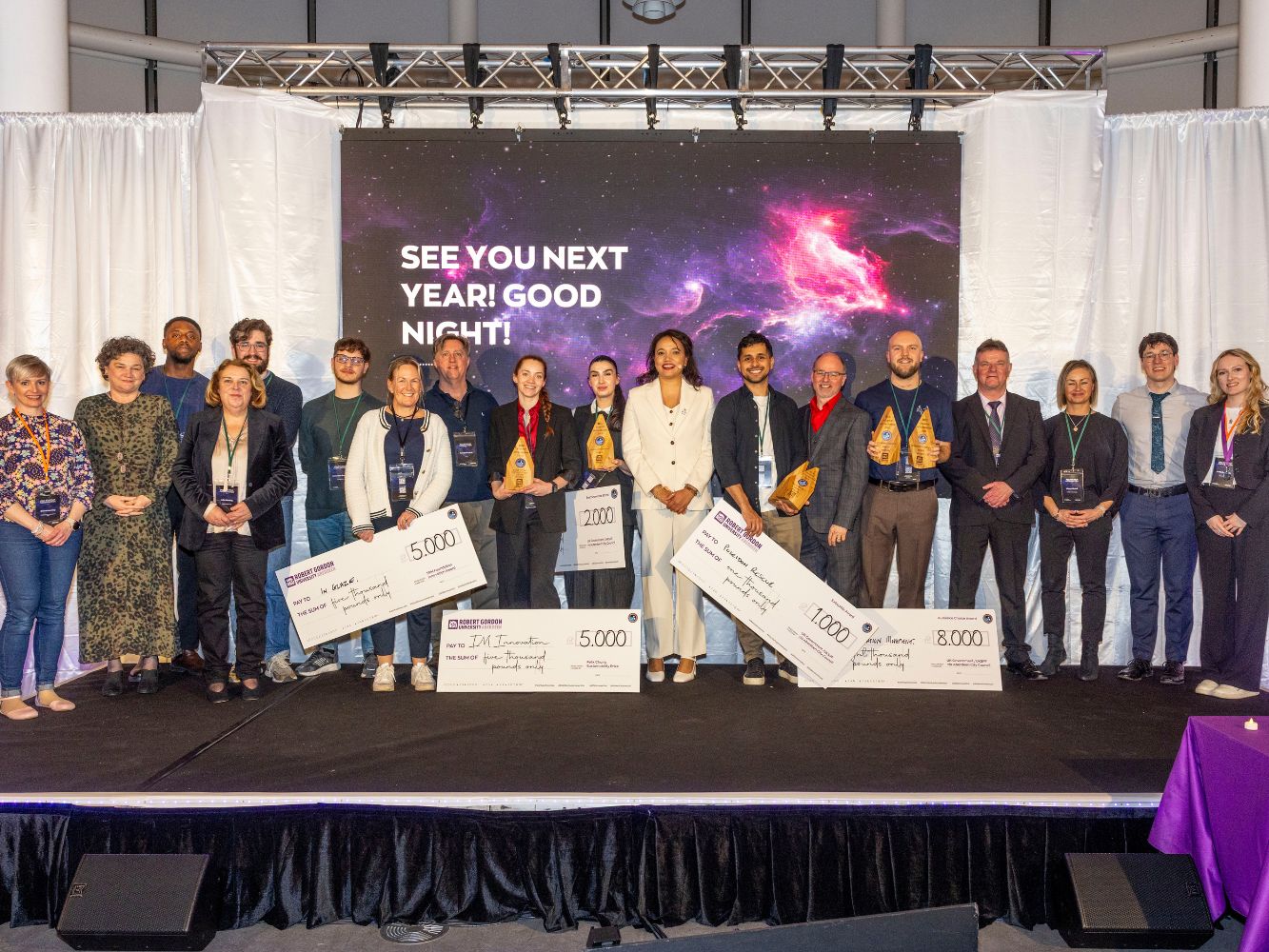 2025 cohort stand with the EIG team following the Showcase