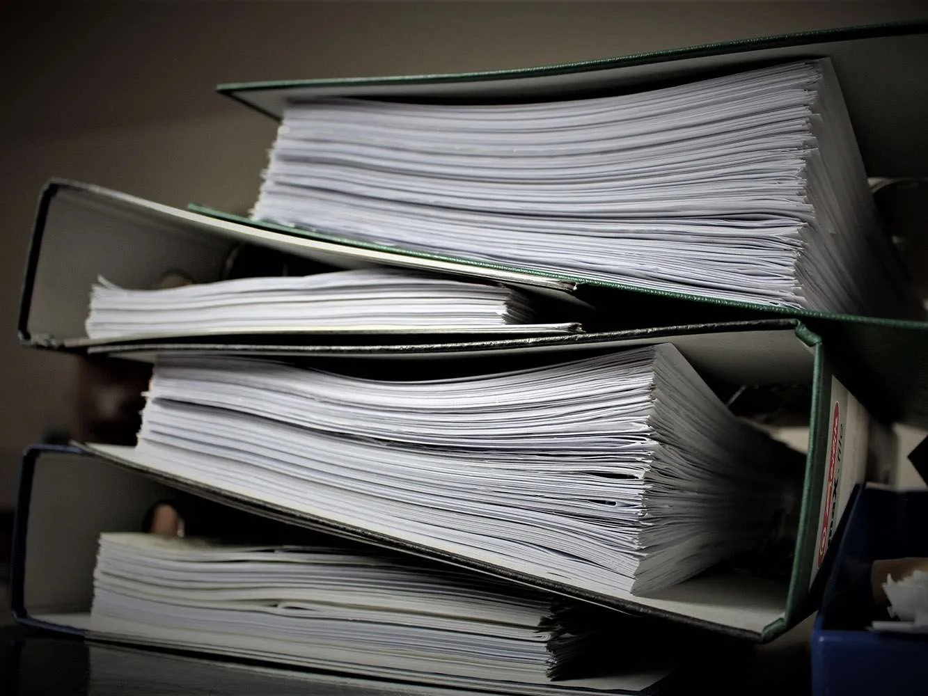 stack of binders full of paper