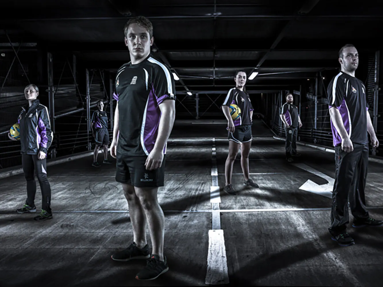 Streetsport volunteers stand in carpark wearing branded leisurewear