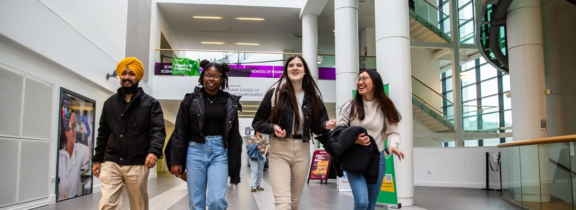 students walking through sir ian wood building