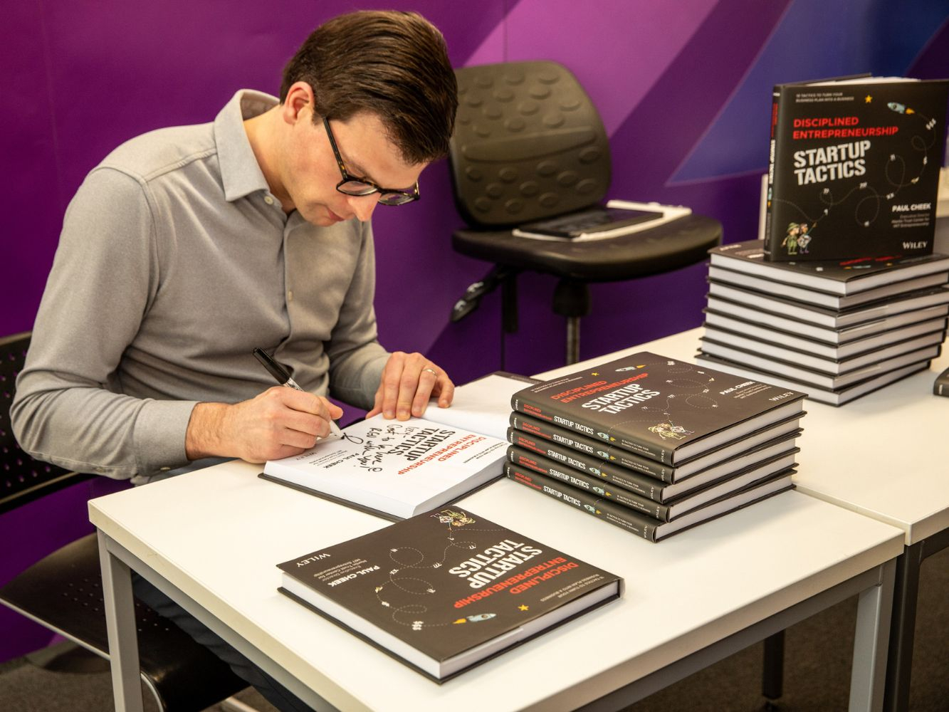 Paul Cheek signing his new book