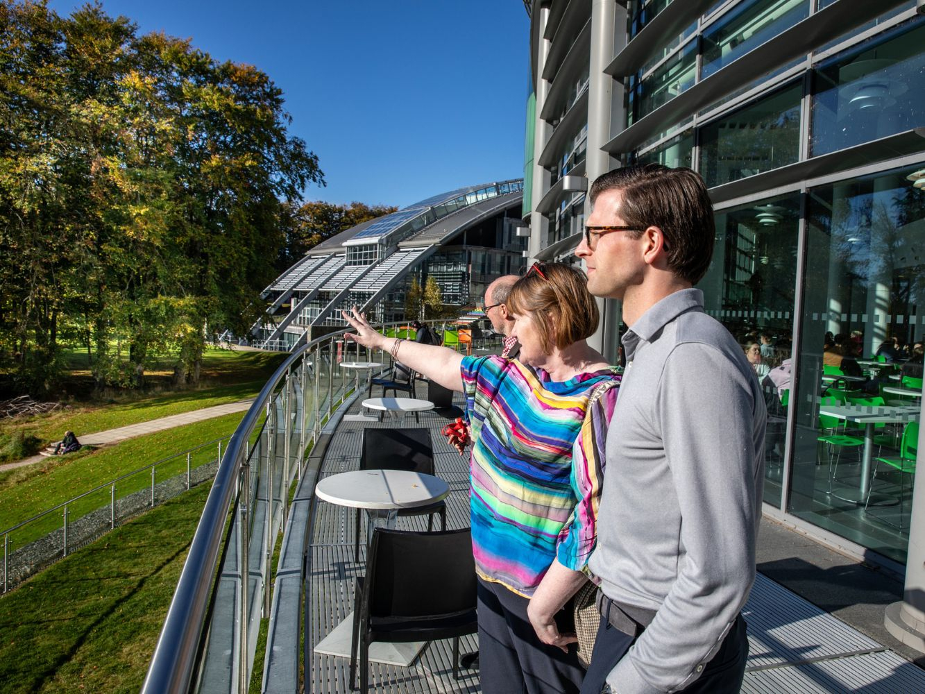 Paul Cheek looks out on RGU's riverside campus alongside Donella Beaton and Chris Moule