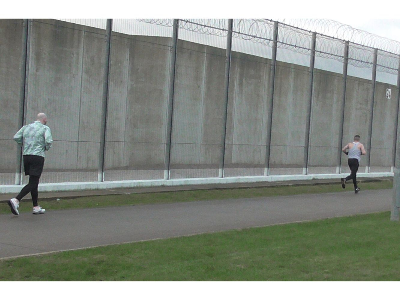 Running participants run around prison walls