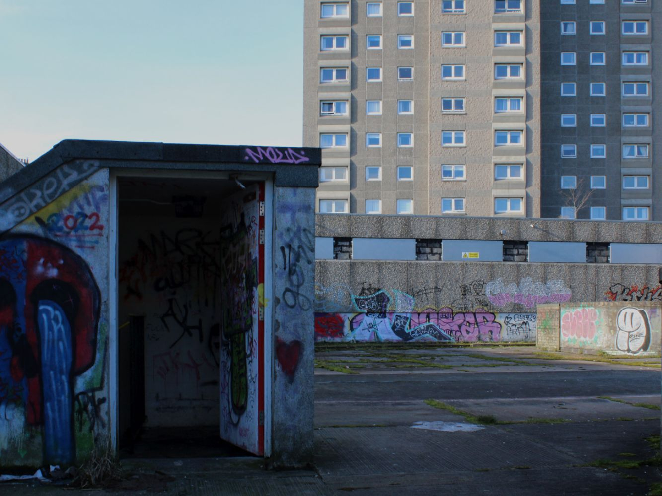 The current Upper Denburn Gardens scene shows overgrown plants, graffiti and uncared for concrete