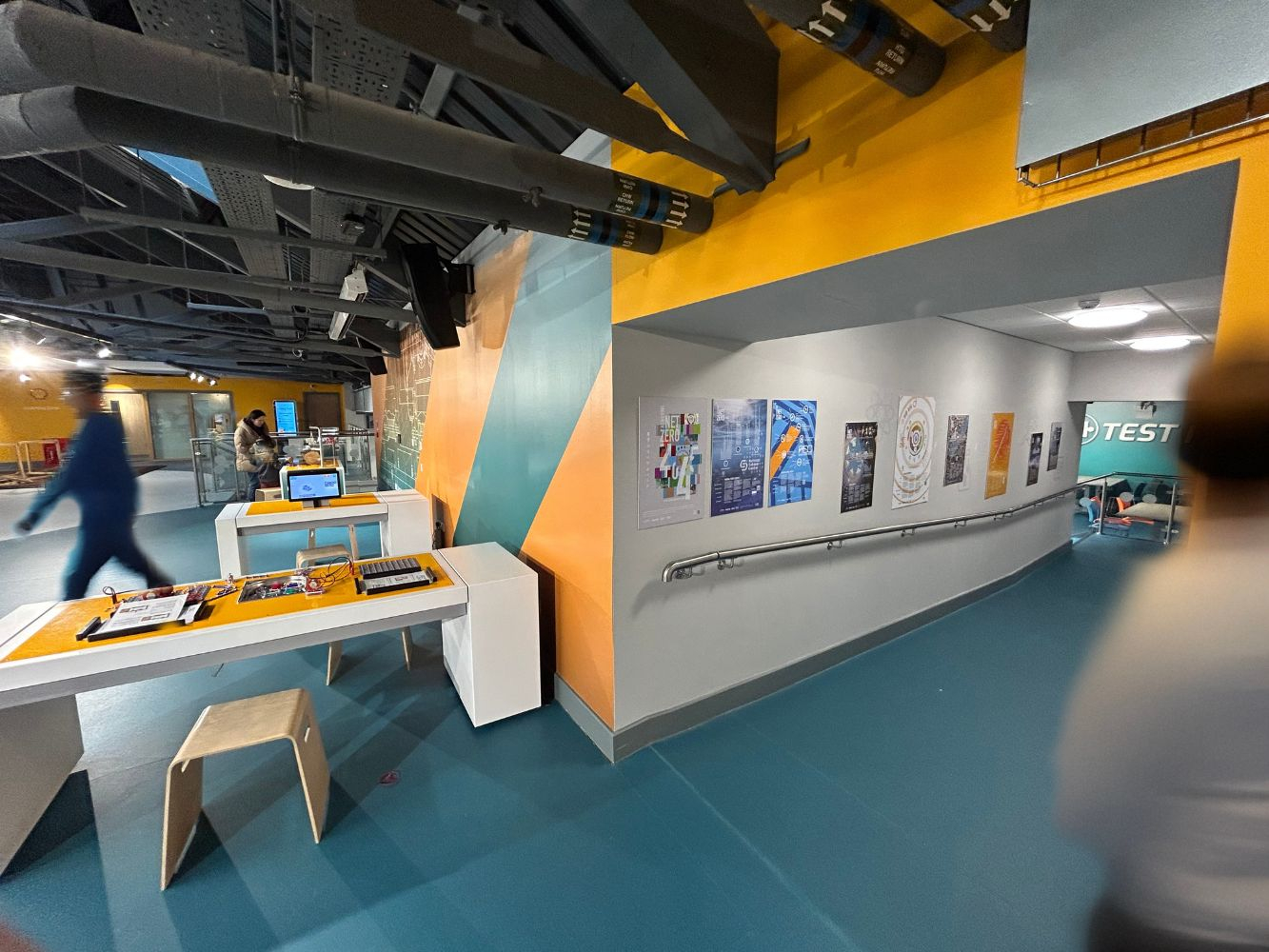 The posters in situ in Aberdeen Science Centre with blurred passers by in the background