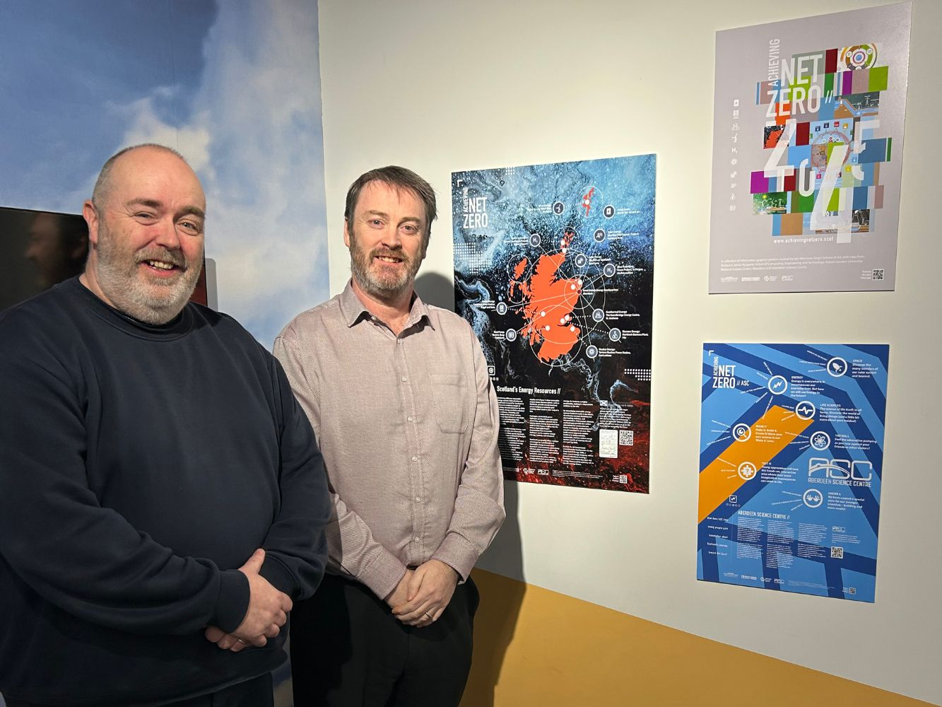 Iain Morrison and Bryan Snelling, quoted, stand next to some of the exhibition