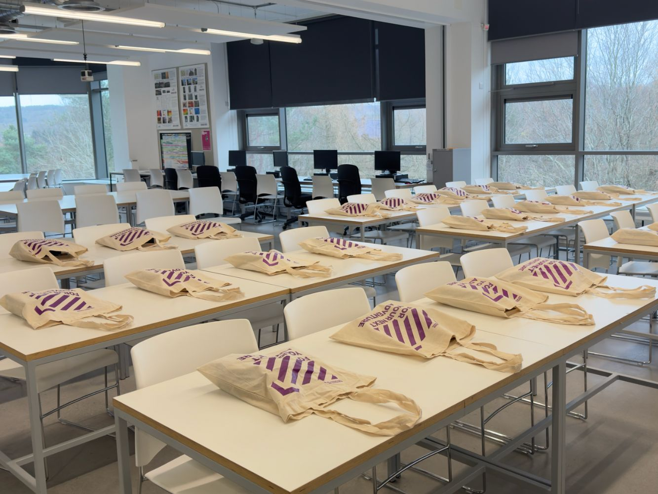 Goodie bags are laid out on the desks ahead of participants joining the room